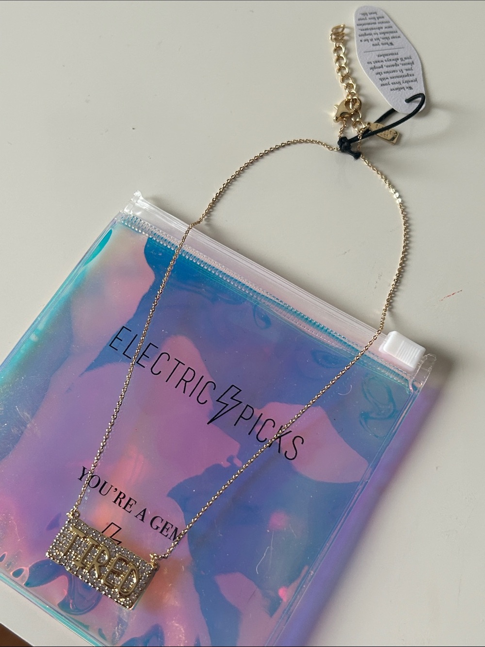 Electric Picks Gold-tone ‘TIRED' Pavé Pendant Necklace with Iridescent Pouch NWT